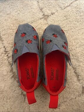 Toms size 7 (toddler) Denim Blue Slip-Ons with Red Ladybug Accents